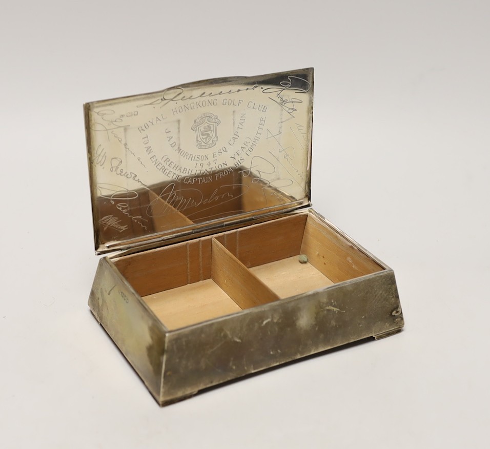 A George VI engine turned silver mounted cigarette box, of tapering rectangular form, the lid interior with engraved inscription relating to the Royal Hong Kong Golf Club, London, 1947, 17.7cm.